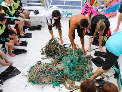 Group of people cleaning the ocean in Oahu